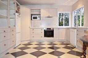 Traditional kitchen in Tusk satin with feature flooring