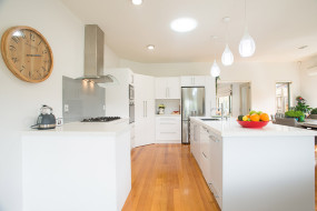 Large Open Plan White Kitchen with Feature Wooden Floor