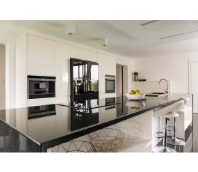 Modern cream kitchen with stylish black appliances