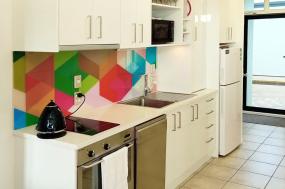 Compact white kitchen with feature tiling