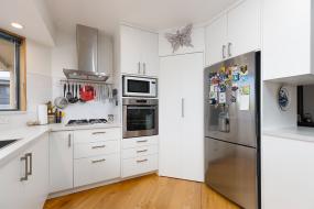 Bright white kitchen with tiled backsplash