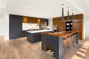 Open-plan kitchen with wood and black door and drawer styles