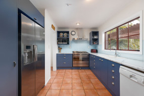 Blue kitchen with light marble effect benchtop