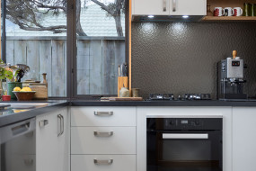 Light grey kitchen with dark benchtop