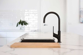Stone benchtop with feature black tapware